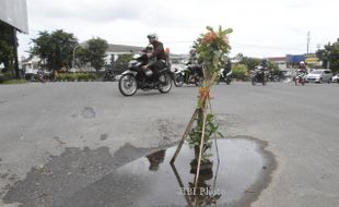 FOTO JALAN RUSAK :  Dipasangi bunga