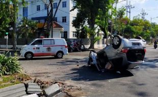 Tabrak Pembatas Jalan, Mobil Brio Terbalik di Surabaya