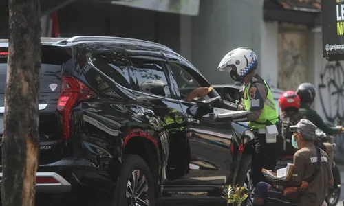 FOTO : Aksi Simpatik, Anggota Satlantas Polresta Solo Bantu Warga Jualan Koran